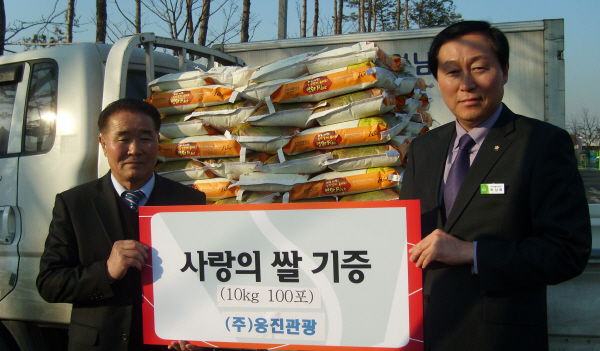윤석영 사장이 박상복 주민생활지원과장에게 쌀을 전달하고 있다.